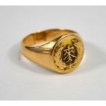 A yellow metal signet ring