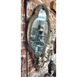 A 19th century giltwood and composite oval mirror
