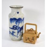 A Yixing teapot and a Chinese vase decorated in underglaze blue