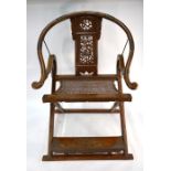 A Chinese brass-mounted folding horseshoe-back campaign chair