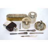 A collection of silver wares including a glass hip-flask with silver bun cover