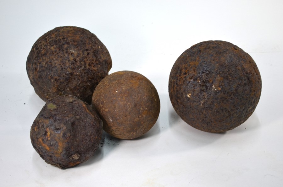 Four cast iron cannon balls