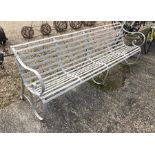 A painted antique wrought iron slatted four seater garden bench