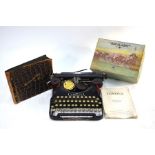A Corona Four portable typewriter, album of photographs and boxed Escalado game