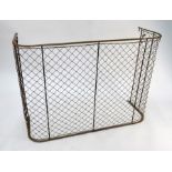 An Edwardian brass framed wire mesh nursery fire guard