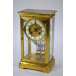 A late 19th century lacquered brass four window eight-day mantel clock