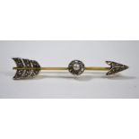 An early 20th century yellow gold diamond and pearl set arrow brooch