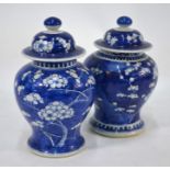 A matched pair of Chinese porcelain blue and white baluster vases and covers