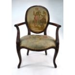 An antique French walnut framed open arm salon chair