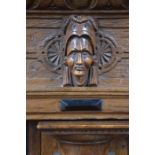 An antique Dutch oak and carved oak press cupboard