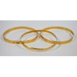Three yellow metal bangles