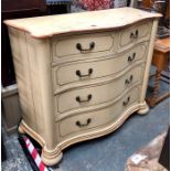 An antique patinated cream painted serpentine chest