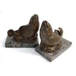 A pair of bronze-patinated spelter 'fish' bookends on marble bases