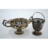 A George III pierced silver basket with swing handle and a Regency sugar basin