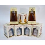 Four Bell's Scotch whisky 70cl Wade decanters, a 18.75 cl decanter and two bottles with contents