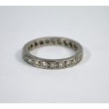A white metal diamond set eternity ring