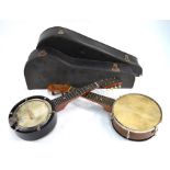 Two banjoleles with leather heads, with cases