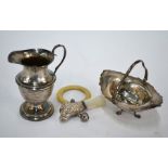 A silver baby's rattle, cream jug and bonbon basket