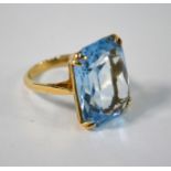 A rectangular single blue stone ring