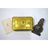 A World War I Queen Mary Christmas tin and a 1887 Jubilee stamped metal spring-clip