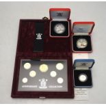 Four cased British coin sets