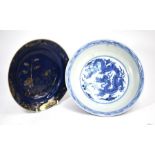A Chinese blue and white dragon dish and a powder blue shallow dish