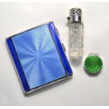 An Art Deco silver cigarette case, a cut glass scent flask and enamel pill-box