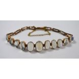 A yellow metal bracelet set with moonstones