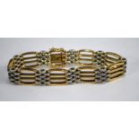 A yellow and white metal fancy gatelink bracelet