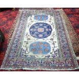 An antique Caucasian camel ground rug