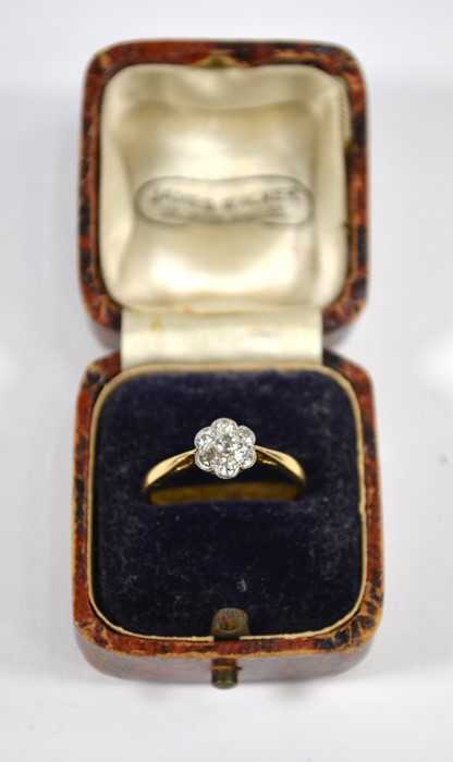 An antique diamond daisy cluster ring