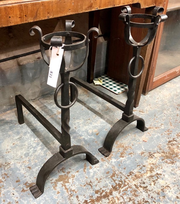 A pair of Arts & Crafts style wrought steel fire dogs