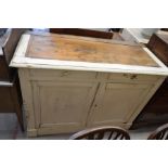 An antique French white painted cabinet with two drawers over two panelled cupboard doors