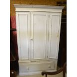 A painted pine wardrobe with panelled door enclosing hanging rail over a single base drawer