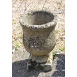 AMENDMENT - A small classical composite cast urn planter on square platform base