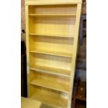 A yellow painted kitchen dining table on turned supports to/w a matching tall open bookcase with