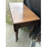 A 19th century mahogany Pembroke table raised on turned support and castors