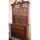 A late Victorian carved mahogany secretaire bookcase with astragal glazed doors enclosing three