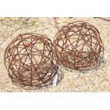 A pair of small armillary garden-art features with spherical weathered metal framework (2)