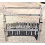 A Cleft style weathered teak garden bench with curved seat, slatted lap and bolt construction