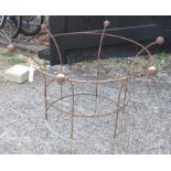 A pair of large weathered metal circular plant frames with cast ball finials (2)