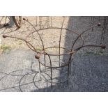 A pair of medium weathered metal circular plant frames with cast ball finials (2)