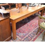 A substantial oak dining table, the rectangular five plank top raised on a plain frieze and square