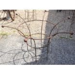 A pair of medium weathered metal circular plant frames with cast ball finials (2)