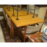 A mid Century teak dining table, rectangular draw leaf top with two central leaves to/w six dining