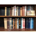 A collection of assorted reference books, autobiographies, novels etc. on four shelves