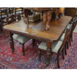 A Victorian mahogany extending wind-out dining table, the canted rectangular top with single central