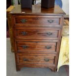 A hardwood tallboy chest of four long drawers raised on bracket feet