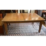 A late 19th century mahogany extending dining table, the canted rectangular top with 'butterfly'