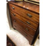 A Georgian mahogany chest of four long graduating drawers with brass handles raised on bracket